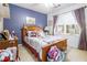 Cozy bedroom with carpeted floors, natural light and wood furniture at 3472 Honeycomb Se Dr, Conyers, GA 30094