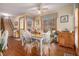 Bright dining area with wood floors, a table for four, and windows overlooking the yard at 3472 Honeycomb Se Dr, Conyers, GA 30094