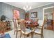 Formal dining room with classic decor, wallpaper, and seating for six at 3472 Honeycomb Se Dr, Conyers, GA 30094