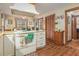 Eat-in kitchen with bright windows, countertops, a white cooktop, and wooden cabinets at 3472 Honeycomb Se Dr, Conyers, GA 30094