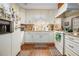 Well-lit kitchen featuring white cabinetry, granite countertops, and modern appliances at 3472 Honeycomb Se Dr, Conyers, GA 30094