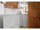 Well-lit laundry room featuring washer, dryer, storage cabinets and shelves at 3472 Honeycomb Se Dr, Conyers, GA 30094