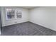 Bedroom with new gray carpet and a large window allowing ample natural light at 3800 William Paul Dr, Austell, GA 30106