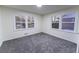 Bright bedroom with plush gray carpeting, and dual windows offering a view of the outdoors at 3800 William Paul Dr, Austell, GA 30106