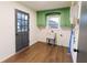 Well-lit laundry room with green cabinets, sink, and access door to the exterior at 3800 William Paul Dr, Austell, GA 30106