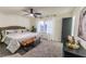 Spacious main bedroom with a ceiling fan, large bed, and neutral decor for a relaxing retreat at 3800 William Paul Dr, Austell, GA 30106