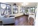 Bright sunroom filled with natural light, featuring large windows and comfortable seating arrangement at 3800 William Paul Dr, Austell, GA 30106