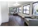 Inviting sunroom with brick accent wall, comfortable seating, and large windows showcasing the outdoor view at 3800 William Paul Dr, Austell, GA 30106