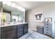 Double vanity bathroom with dark brown cabinets and large mirror at 7144 Gladstone Cir, Stonecrest, GA 30038