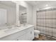 Bathroom with double vanity and striped shower curtain at 7767 Richmond Trl, Fairburn, GA 30213