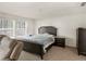 Main bedroom with dark wood furniture and gray bedding at 7767 Richmond Trl, Fairburn, GA 30213