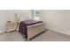 Bedroom with light wood furniture and purple bedding at 7767 Richmond Trl, Fairburn, GA 30213