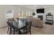 Open dining area with large table, hardwood floors, and access to the kitchen at 7767 Richmond Trl, Fairburn, GA 30213