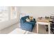 Home office with a blue couch and a wooden desk by the window at 7767 Richmond Trl, Fairburn, GA 30213