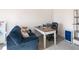 Bright home office featuring a desk, comfortable couch, and built-in shelving at 7767 Richmond Trl, Fairburn, GA 30213