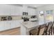 Modern kitchen with white cabinets, granite countertops, and a large island at 7767 Richmond Trl, Fairburn, GA 30213