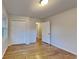 Hardwood floor bedroom with double door closet and access to the bathroom at 4129 Shorter Way, Decatur, GA 30034