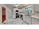 Kitchen with white cabinets, stainless steel appliances, and marble tile floor at 4129 Shorter Way, Decatur, GA 30034