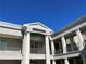 Architectural detailing showcasing pillars and balcony with decorative iron railings and stone exterior under blue sky at 58 Canton St # 303, Alpharetta, GA 30009