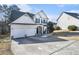 Two-story house with three-car garage and large driveway at 3055 Cooper Woods Ln, Loganville, GA 30052