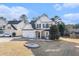 Two-story house with stone accents and a three-car garage at 3055 Cooper Woods Ln, Loganville, GA 30052