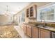 Open kitchen with granite counters and view of living room at 3055 Cooper Woods Ln, Loganville, GA 30052