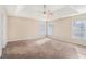 Main bedroom with tray ceiling and neutral carpet at 3055 Cooper Woods Ln, Loganville, GA 30052