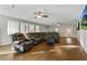 Living room with hardwood floors, sectional sofa, and large TV at 4522 Karron Ln, Powder Springs, GA 30127
