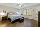 Spacious main bedroom with hardwood floors, a king-size bed, and ample natural light at 4522 Karron Ln, Powder Springs, GA 30127