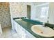 Bathroom with double sinks, green countertops, and a bathtub at 95 Brandon Dr, Covington, GA 30016