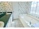 Bathroom with double sinks, bathtub, and floral wallpaper at 95 Brandon Dr, Covington, GA 30016