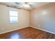 Spacious bedroom featuring wood-look floors and a large window at 95 Brandon Dr, Covington, GA 30016