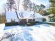 Snow-covered house with stone accents and landscaping at 95 Brandon Dr, Covington, GA 30016