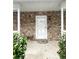 Stone front entry with white door and a pink welcome mat at 95 Brandon Dr, Covington, GA 30016