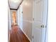 Hallway with wood-look floors and access to bathroom at 95 Brandon Dr, Covington, GA 30016