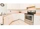 Bright kitchen with white cabinets and stainless steel range at 95 Brandon Dr, Covington, GA 30016
