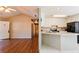 Kitchen with white cabinets, black appliances, and breakfast bar at 95 Brandon Dr, Covington, GA 30016