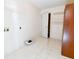 Laundry room with wood cabinet and tiled floor at 95 Brandon Dr, Covington, GA 30016