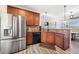 Kitchen area featuring stainless steel appliances, wood cabinets, granite countertops, and tiled backsplash at 417 Culloden Moor Dr, Mcdonough, GA 30253