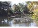 Picturesque gazebo on a dock, surrounded by calm water and lush greenery at 4361 Hardwood Sw Cir, Lilburn, GA 30047