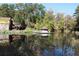 Tranquil pond reflecting the house and trees, creating a serene atmosphere at 4361 Hardwood Sw Cir, Lilburn, GA 30047