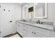 Double vanity bathroom with granite countertops and modern lighting at 4611 Eberline Ct, Stone Mountain, GA 30083