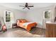 Cozy bedroom with wood-look floors and orange bedding at 4611 Eberline Ct, Stone Mountain, GA 30083