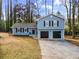 Newly renovated light blue home with a two-car garage and manicured lawn at 4611 Eberline Ct, Stone Mountain, GA 30083