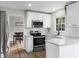 Modern kitchen features white cabinets, granite countertops, and stainless steel appliances at 4611 Eberline Ct, Stone Mountain, GA 30083