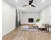 Bright living room with fireplace, hardwood floors, and a comfy sofa at 4611 Eberline Ct, Stone Mountain, GA 30083