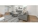 Spacious living room with hardwood floors and a large sectional sofa at 4611 Eberline Ct, Stone Mountain, GA 30083