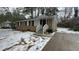 Tan brick ranch house with a covered entry and snowy front yard at 3770 Larkspur Ter, Decatur, GA 30032