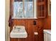 Small bathroom with wood paneled walls and vintage vanity at 3781 Narmore Ne Dr, Atlanta, GA 30319