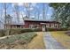 Red wooden home with stone walkway and landscaping at 3781 Narmore Ne Dr, Atlanta, GA 30319